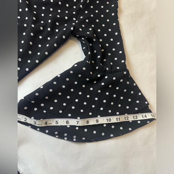 Brand: NAIF, black dress, with white dots, and flared sleeves - Picture 7 of 12